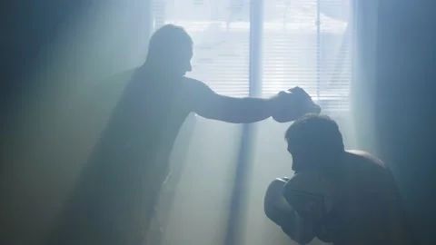 The boxer hits the paws held by the trainer with gloves Stock Footage 237433956