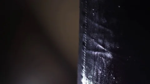 Boxer hitting punching black bag with glove water sprays Video stock 80819752