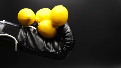 Boxer holding full lemons then dropping them in slow motion turning a loss into Stock Footage 205438757