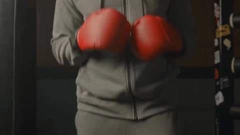Boxer Jumping During Indoor Training in Grey Sportswear and Red Gloves Stock Footage 314303123