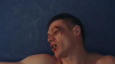 Boxer knocked out and lying on the ground Stock Footage 283294532