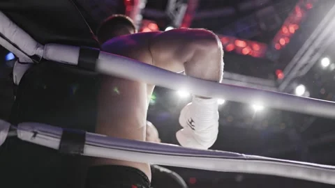 Boxer leaning on boxing ring ropes in slow motion Stock Footage 309058496