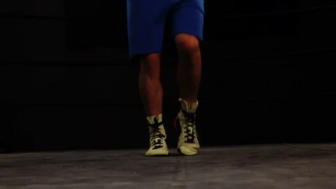 Boxer making rope jumps in the ring, close up feet moves slow motion Stock Footage 101213528