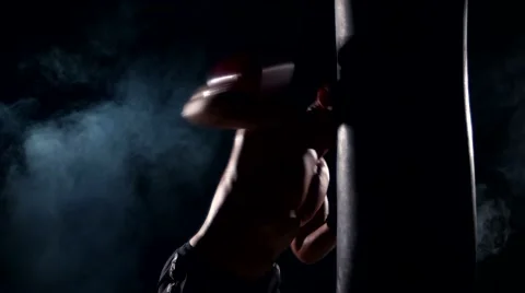 Boxer man during boxing hiting heavy bag at training fitness gym Stock Footage