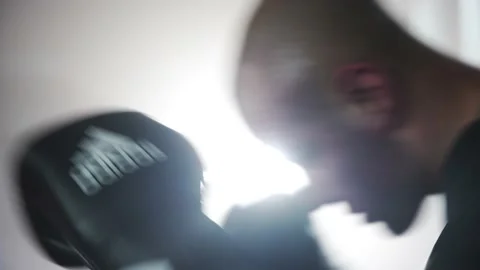 Boxer Man Hitting Heavy Red Bag during Boxing Workout in the Gym Stock Footage 174926577