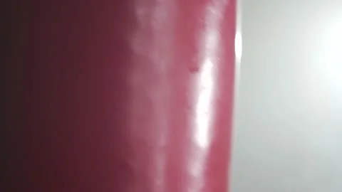 Boxer Man Hitting Heavy Red Bag during Boxing Workout in the Gym Stock Footage 174926869