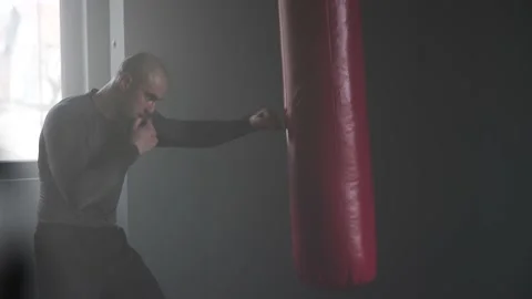 Boxer Man Hitting Heavy Red Bag during Boxing Workout in the Gym Stock Footage 174929095