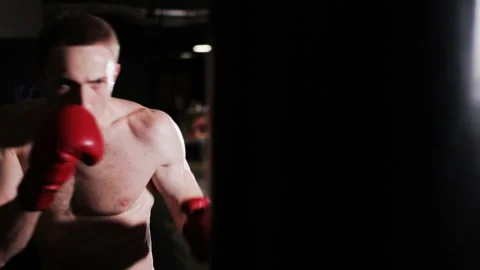 Boxer man puts punches on the punching bag. slow motion Stock Footage 88743115