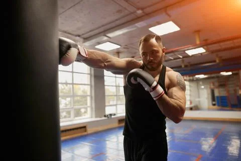 Boxer placing a right during workout Stock Photos