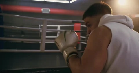 A boxer practices punching techniques in front of a mirror. Stock Footage 275275899
