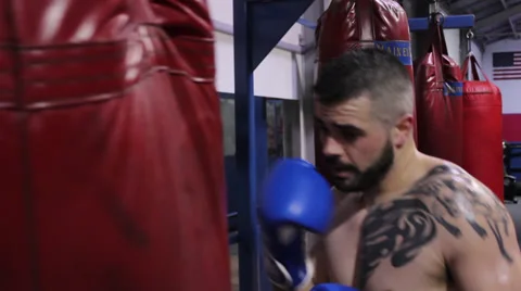 Boxer Practicing on Heavy Bag Stock Footage 38935390