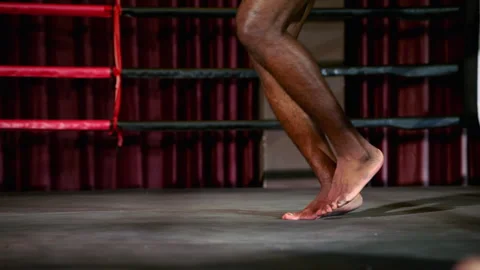 Boxer practicing jumping rope for footwork practice inside gym Stock Footage 241321590