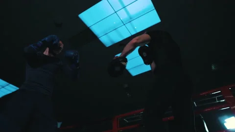 Boxer practicing punches with coach on boxing ring Stock Footage 144317284