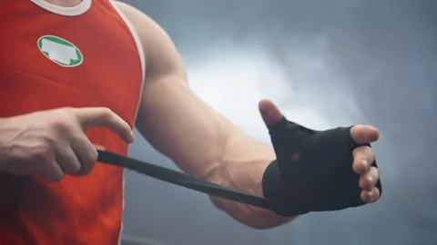 Boxer preparing for training. Fighter wrapping hands before fighting. Stock-Footage 273207623