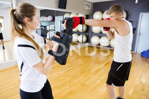 Boxer Punching Bag Held By Female Instructor Stock Photos