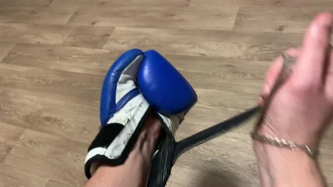 A boxer puts on a boxing glove before training Stock Footage 150001717
