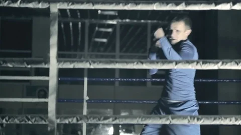 Boxer in the ring trains fast punches. preparing for the battle. Dark background Stock Footage 81521419