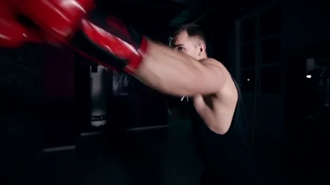 A boxer shadow boxes in the gym 動画素材 75907598