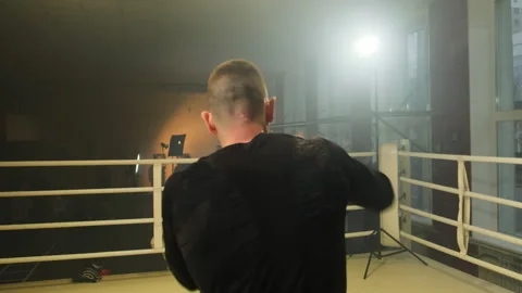 Boxer shadowboxes simulating real contact with opponent Stock Footage 306666760