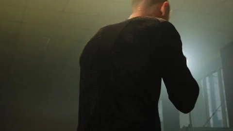 Boxer simulates real sparring in spacious dimly lit hall 스톡 동영상 306667512