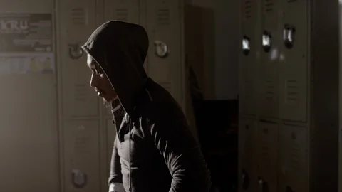 Boxer sitting on bench looking down in musty locker room Video stock 104537766