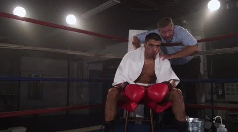 Boxer sitting in corner of ring preparing for fight Video stock 62282434