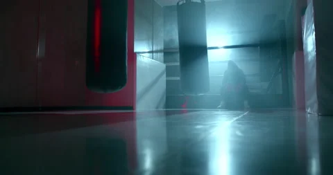 A boxer is sitting in the ring in the gym after the fight and is resting Stock Footage 157899075