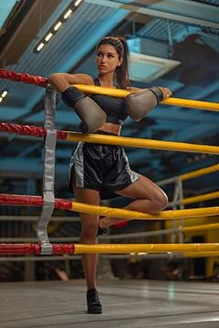 Boxer stands in training ring showcasing strength and determination during Stock Photos
