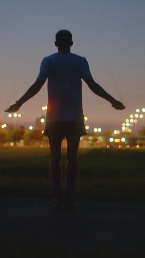 Boxer style warmup with rapid jumping under city illumination Stock Footage 324592144