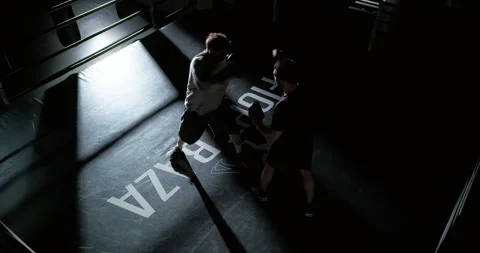 Boxer training with coach in boxing paws in the ring, preparing for competition Stock Footage 309130870