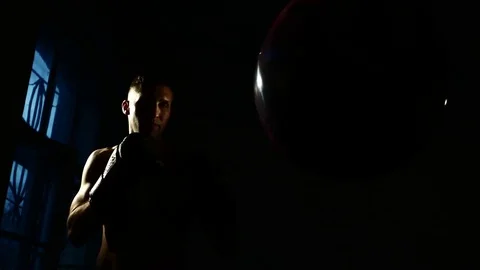 Boxer training in a gym, dramatic lighting. 4k Stock Footage 75784552