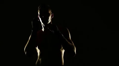 Boxer training in a gym, dramatic lighting Stock Footage 75784944