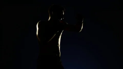Boxer training in a gym, dramatic lighting Stock Footage 75797402