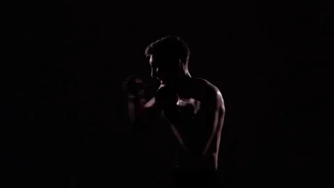 Boxer training in a gym, dramatic lighting Stock Footage 75827099