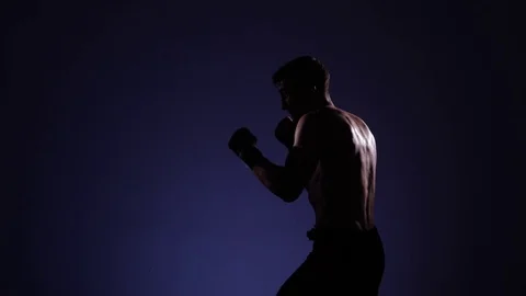 Boxer training in a gym, dramatic lighting Stock Footage 75827286