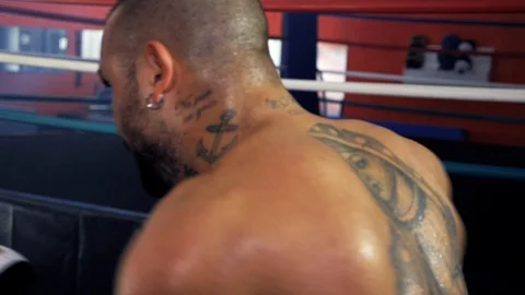 Boxer training in gym hitting bag hard slow motion closeup Stock Footage 117426478