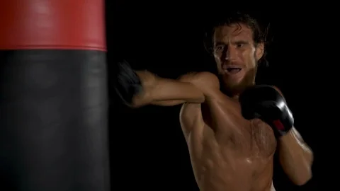 Boxer training kickboxing in the darkness. Video stock 85854201