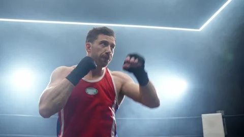 Boxer training in low light gym. Man learning fighting skill. Fight concept. Stock Footage 274385838