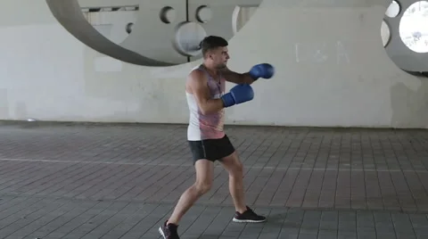 Boxer is on a training outdoors under bridge. Stock Footage 68757008