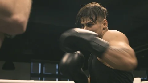Boxer training punches with partner Stock Footage 89809139