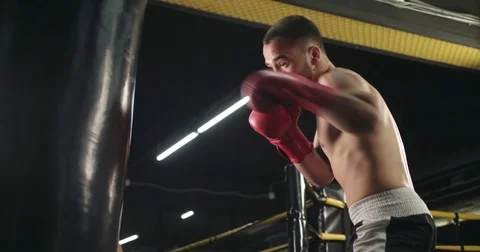 Boxer training punching bag 4k close-up video. Fighter blows jab cross punch Stock Footage 70405342