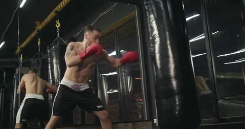 Boxer training punching bag 4k video. Fighter blows jab cross punch fight series Stock Footage 70406216