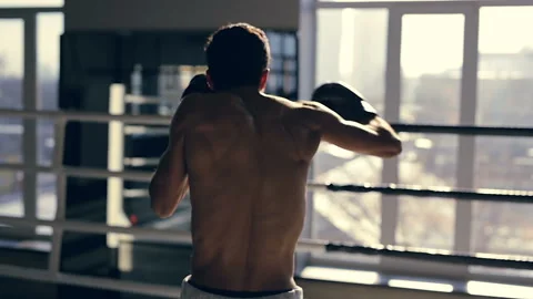 Boxer training at the ring. Looking at window and hitting the air. Stock-Footage 98680057