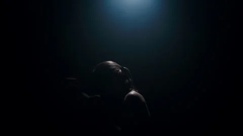 Boxer training, silhouetted against a background of light, practicing punches  Stock Footage 274449275