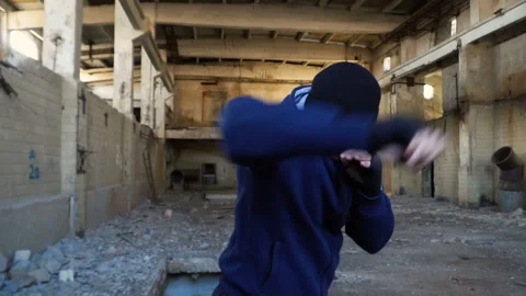 A boxer trains in an abandoned building. Video stock 89761350