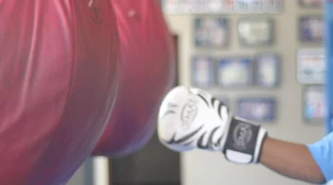 Boxer trains on punching bag Stock Footage 63077671