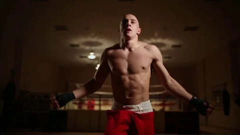 Boxer warming up before a workout. Performs a jumping rope on the background of Stock Footage 83950045