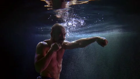 Boxer water training is a difficult situation of practicing punches. Coaches 스톡 동영상 166105837