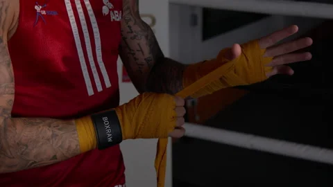 Boxer wrapping his hands in slow motion Stock Footage 165449621