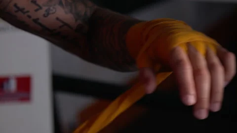 Boxer wrapping his left hand in slow motion Stock Footage 165449738